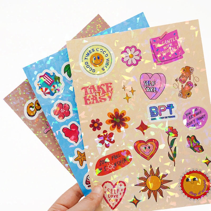 Holographic cartoon sticker sheets held by hand