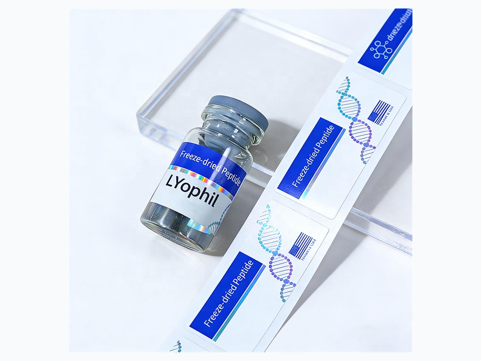 Blue vial label roll with small bottle sample